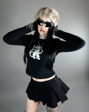Chaos Longsleeve Tee - Thumb Holes & Silver Embroidery styled with black mini skirt and fur hat. Features cropped fit and gothic silver chest design.