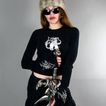 Chaos Longsleeve Tee - Thumb Holes & Silver Embroidery styled with fur hat and sword. Features cropped fit and gothic silver detailing on sleeves and chest.