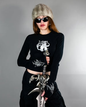 Chaos Longsleeve Tee - Thumb Holes & Silver Embroidery styled with fur hat and sword. Features cropped fit and gothic silver detailing on sleeves and chest.