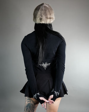 Chaos Longsleeve Tee in black with silver embroidery on sleeves and lower back, featuring thumb holes and a cropped fit for womens  wear.