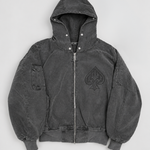 A dark gray washed corduroy hooded jacket with a front zipper, ribbed cuffs and hem, and a large tonal spade logo on the left chest, shown flat against a light gray background.